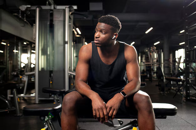 files/young-serious-african-american-man-sits-dark-gym-looks-away-sports-guy-fitness-club_164411-4082.avif